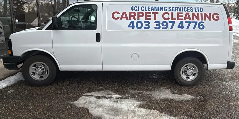 The white 4CJ Cleaning Services van parked in winter, lettered Carpet Cleaning with the phone number on its side